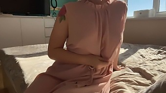 A Woman In A Soft Pink Gown Explores Her Sensual Desires